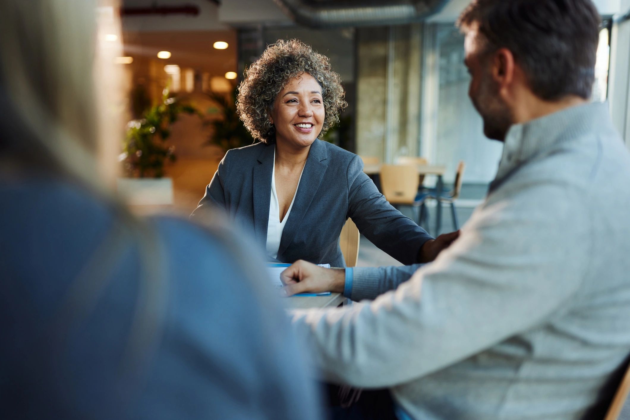 Consultant speaking with colleagues during a meeting